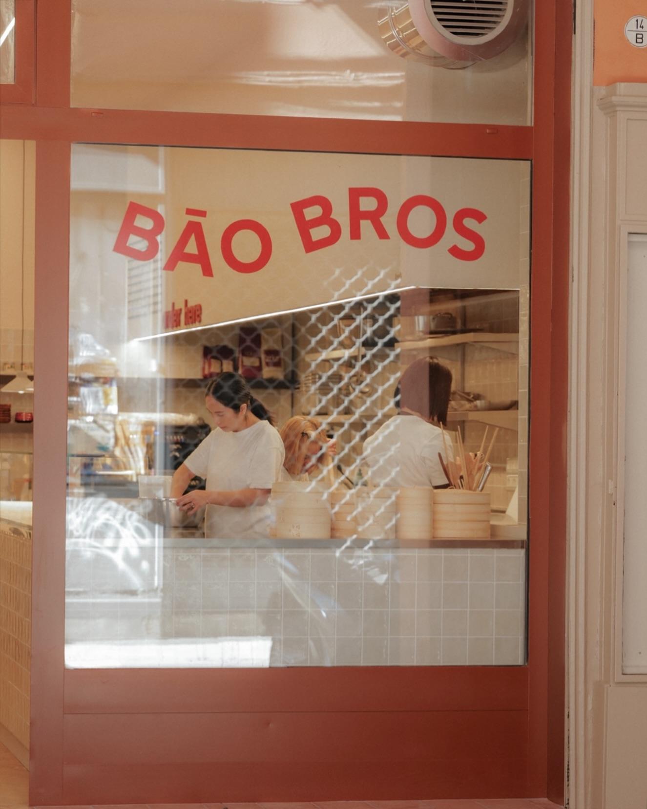 The Bao Bros window on Via Nazario Sauro, the name arched across the glass and, behind it, the counter with its bamboo steamers.